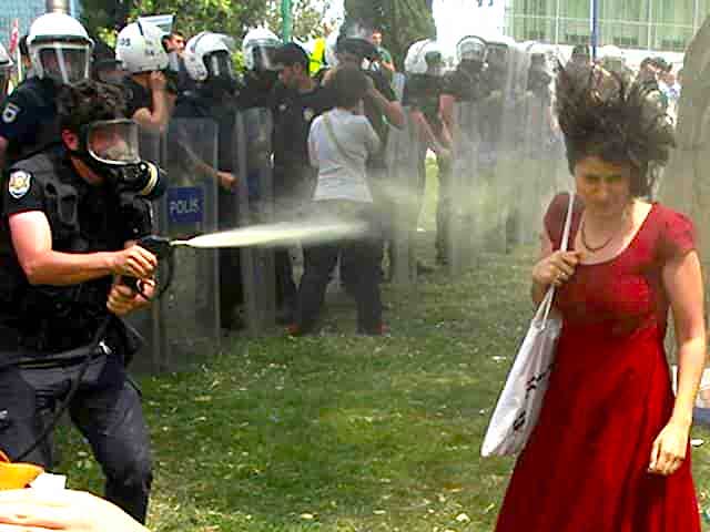 woman in red dress being tear-gassed